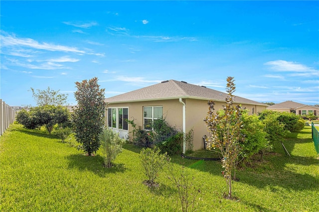 view of property exterior with a lawn