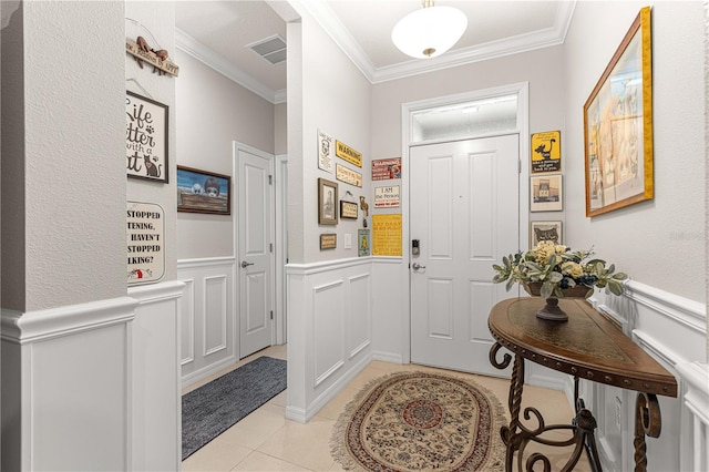 tiled foyer entrance featuring ornamental molding