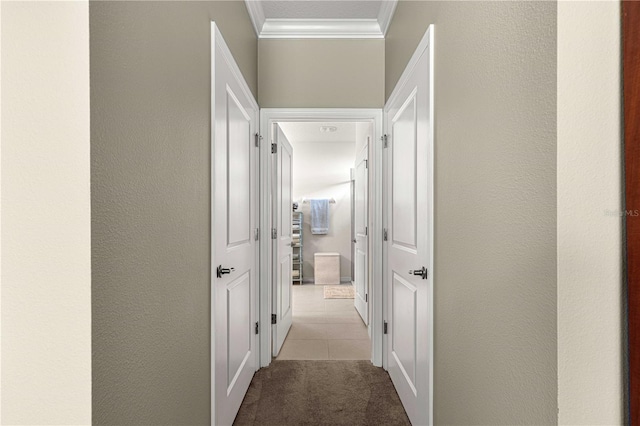 hall featuring light tile patterned flooring and ornamental molding