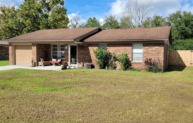 ranch-style home featuring a garage and a front yard