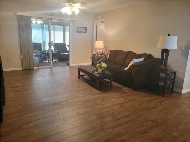 living room featuring dark hardwood / wood-style flooring and ceiling fan