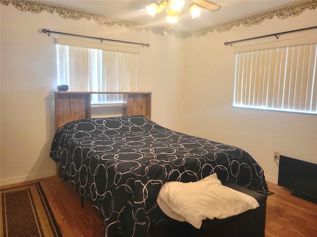 bedroom with hardwood / wood-style floors and ceiling fan