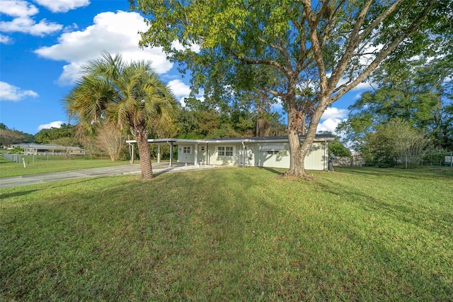 ranch-style home with a carport and a front lawn