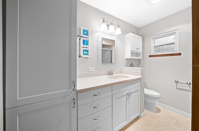 bathroom with tile patterned floors, vanity, and toilet