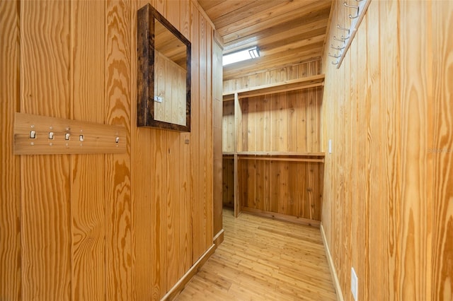 interior space with wood walls, wood ceiling, and hardwood / wood-style flooring