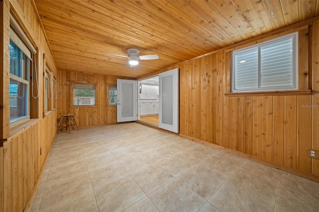 unfurnished room with wood ceiling, ceiling fan, cooling unit, light tile patterned floors, and wood walls