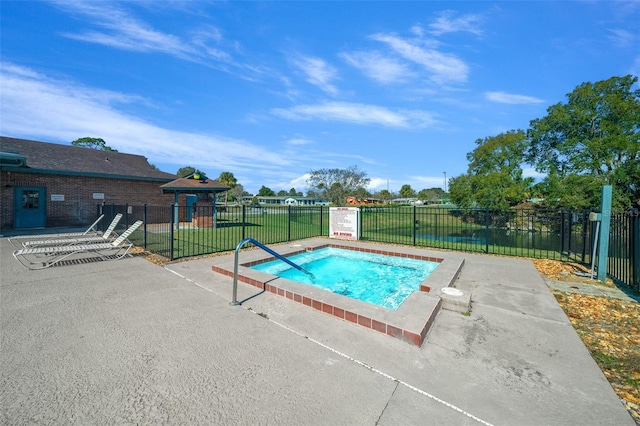 view of swimming pool featuring a yard, a patio, and a hot tub