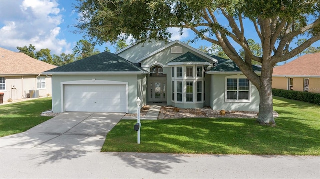 single story home featuring a garage, a front yard, and central AC