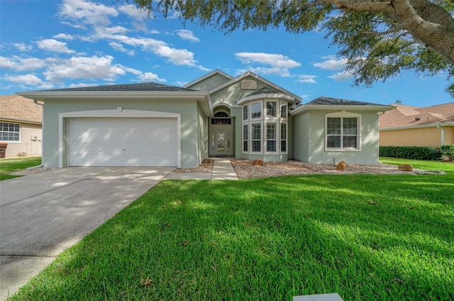 single story home featuring a garage, driveway, a front yard, and stucco siding