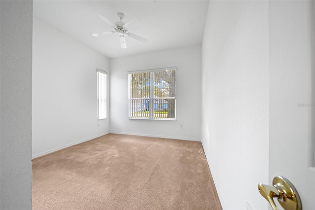 unfurnished room featuring ceiling fan, carpet flooring, and baseboards