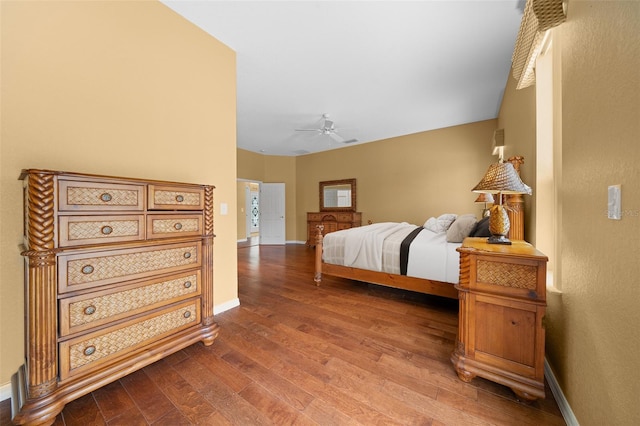 bedroom with dark wood-style floors, ceiling fan, and baseboards