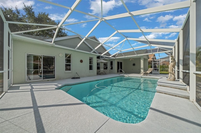 outdoor pool featuring a lanai and a patio area