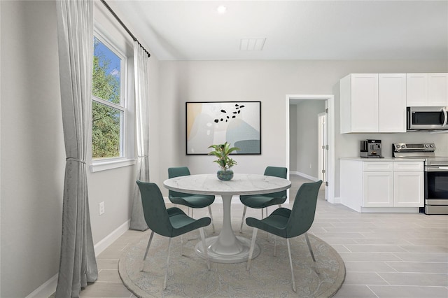 dining space with light hardwood / wood-style floors