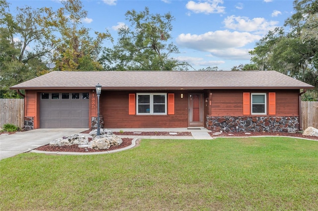 single story home with a garage and a front lawn