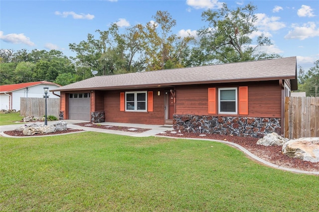 ranch-style house with a garage and a front lawn