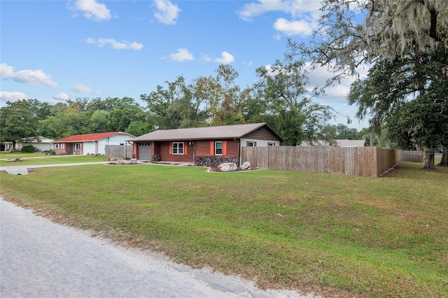 ranch-style home featuring a garage and a front yard