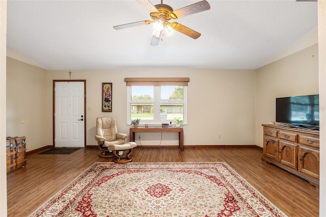 sitting room featuring ceiling fan, a textured ceiling, and light hardwood / wood-style floors