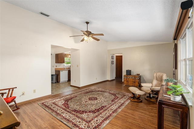 living room with hardwood / wood-style flooring, a healthy amount of sunlight, and a textured ceiling