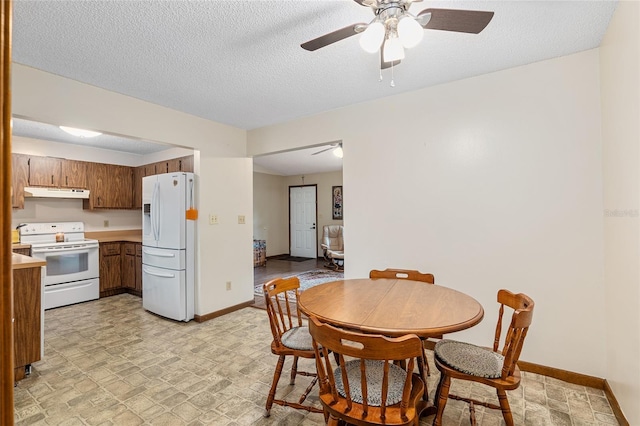 dining area with a textured ceiling and ceiling fan