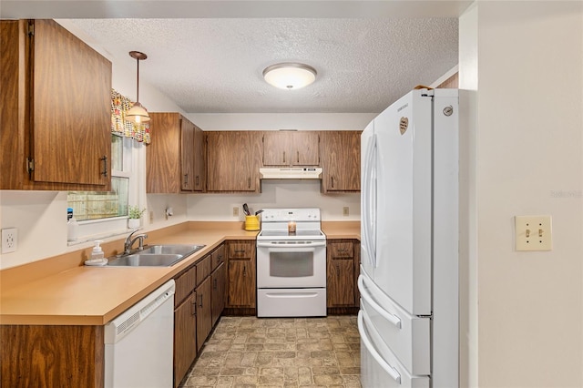 kitchen with hanging light fixtures, white appliances, a textured ceiling, and sink