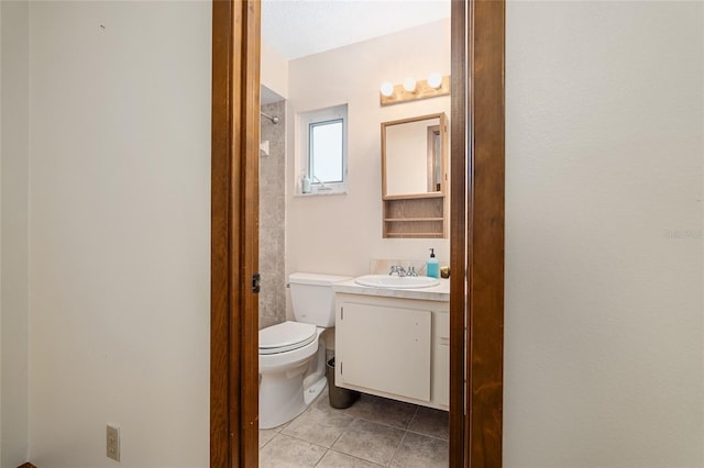 bathroom featuring vanity, tile patterned floors, and toilet