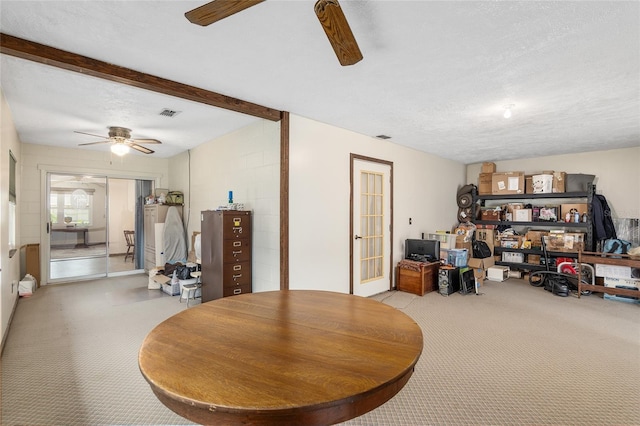 dining room featuring a textured ceiling, ceiling fan, and beam ceiling