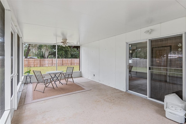 sunroom featuring ceiling fan