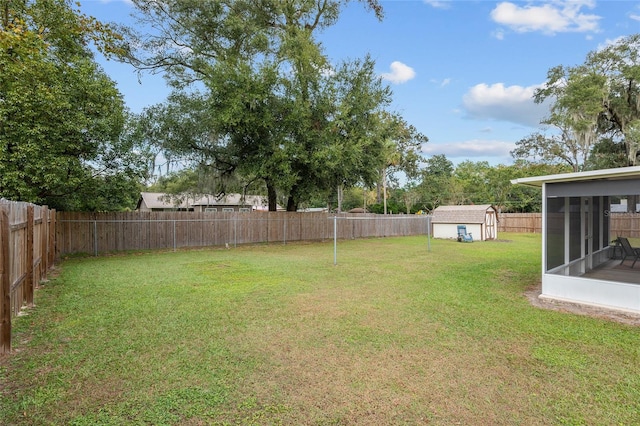 view of yard featuring a storage unit and a sunroom