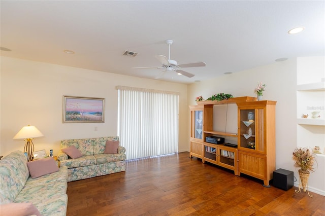 living room featuring dark hardwood / wood-style flooring and ceiling fan