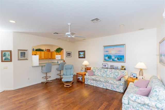 living room featuring hardwood / wood-style flooring and ceiling fan