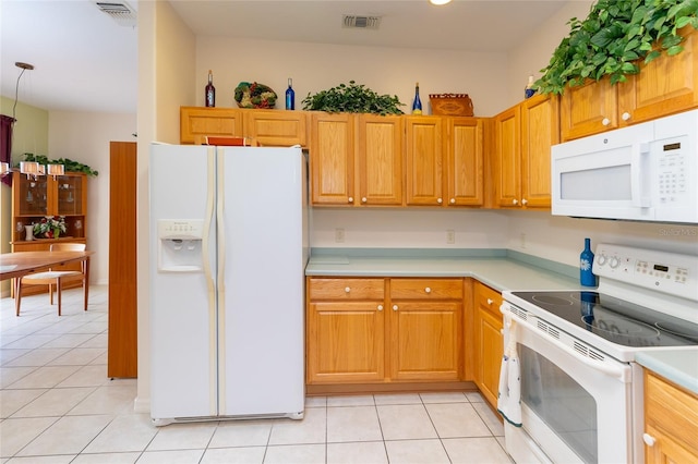 kitchen featuring light tile patterned floors and white appliances