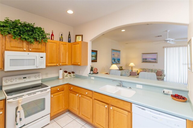 15659 SW 13th Cir, Ocala, FL 34473 - kitchen with white appliances, a sink, arched walkways, light countertops, and recessed lighting