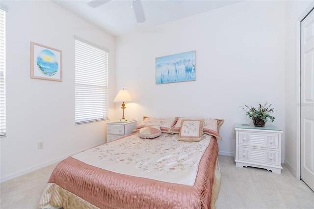 bedroom featuring ceiling fan and light carpet