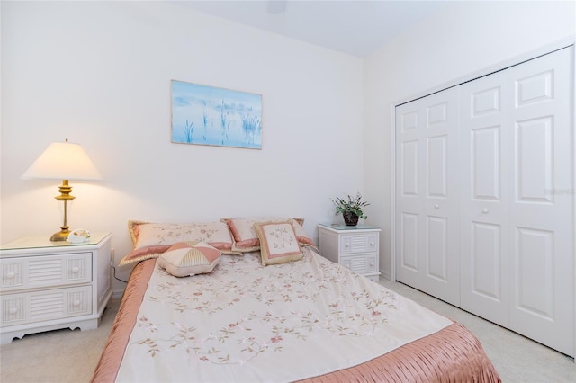 bedroom featuring light carpet and a closet