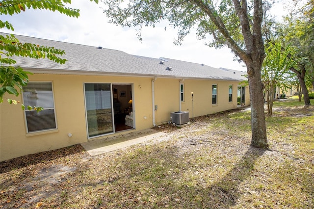 rear view of house featuring central AC