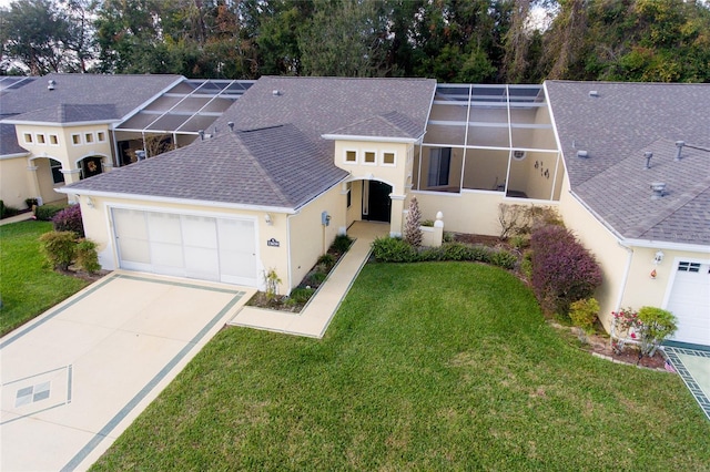 view of front of property featuring a garage, a front yard, and a lanai