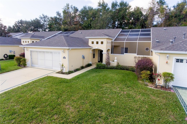 view of front of property with a lanai, a garage, and a front lawn