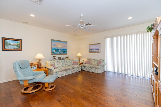 living room with wood-type flooring and ceiling fan