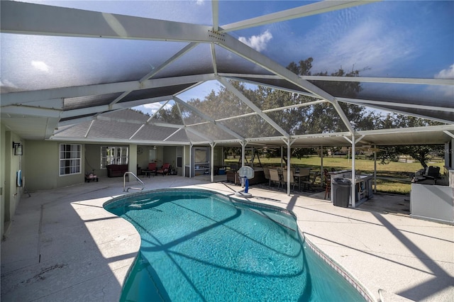 view of pool featuring glass enclosure and a patio area