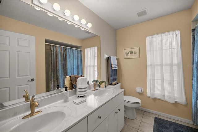 5537 SW 38th St, Ocala, FL 34474 - full bath with tile patterned floors, toilet, double vanity, and baseboards