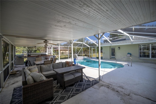 view of pool with an outdoor living space, a patio area, and glass enclosure