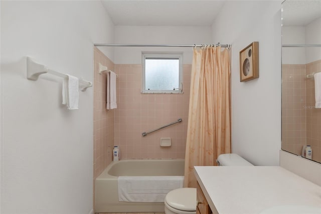 full bathroom with vanity, shower / tub combo, and toilet