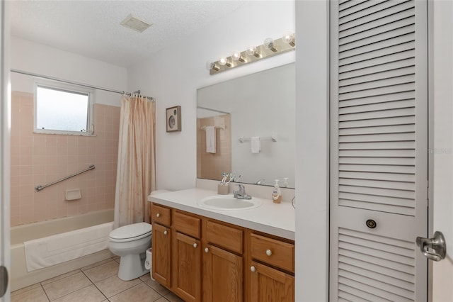 full bathroom with vanity, shower / bath combo, tile patterned floors, toilet, and a textured ceiling