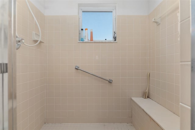 bathroom with tiled shower