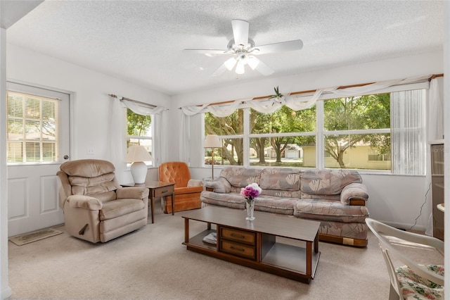 sunroom featuring ceiling fan and plenty of natural light