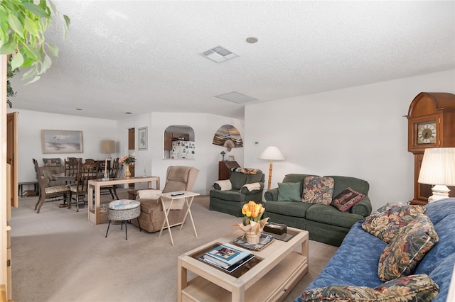 carpeted living room with a textured ceiling