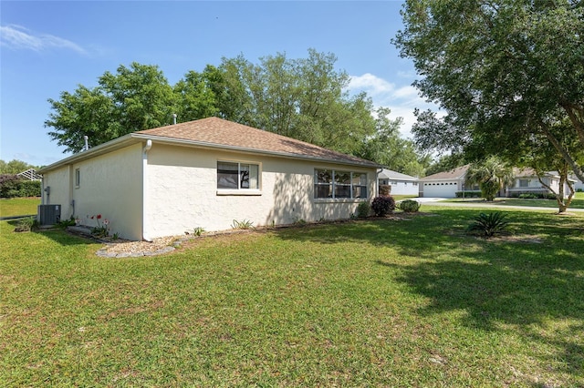 view of home's exterior with a yard and cooling unit