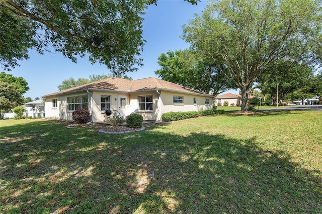 rear view of house with a yard