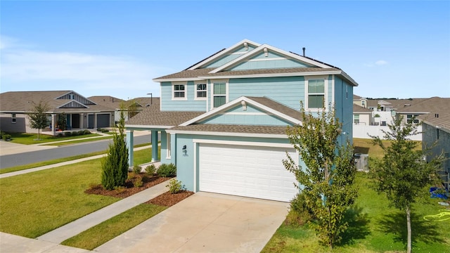 view of front of property with a garage and a front yard