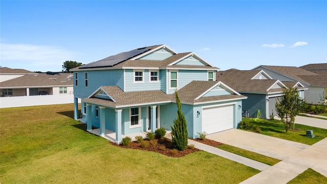 view of front of property featuring a garage, solar panels, covered porch, and a front yard